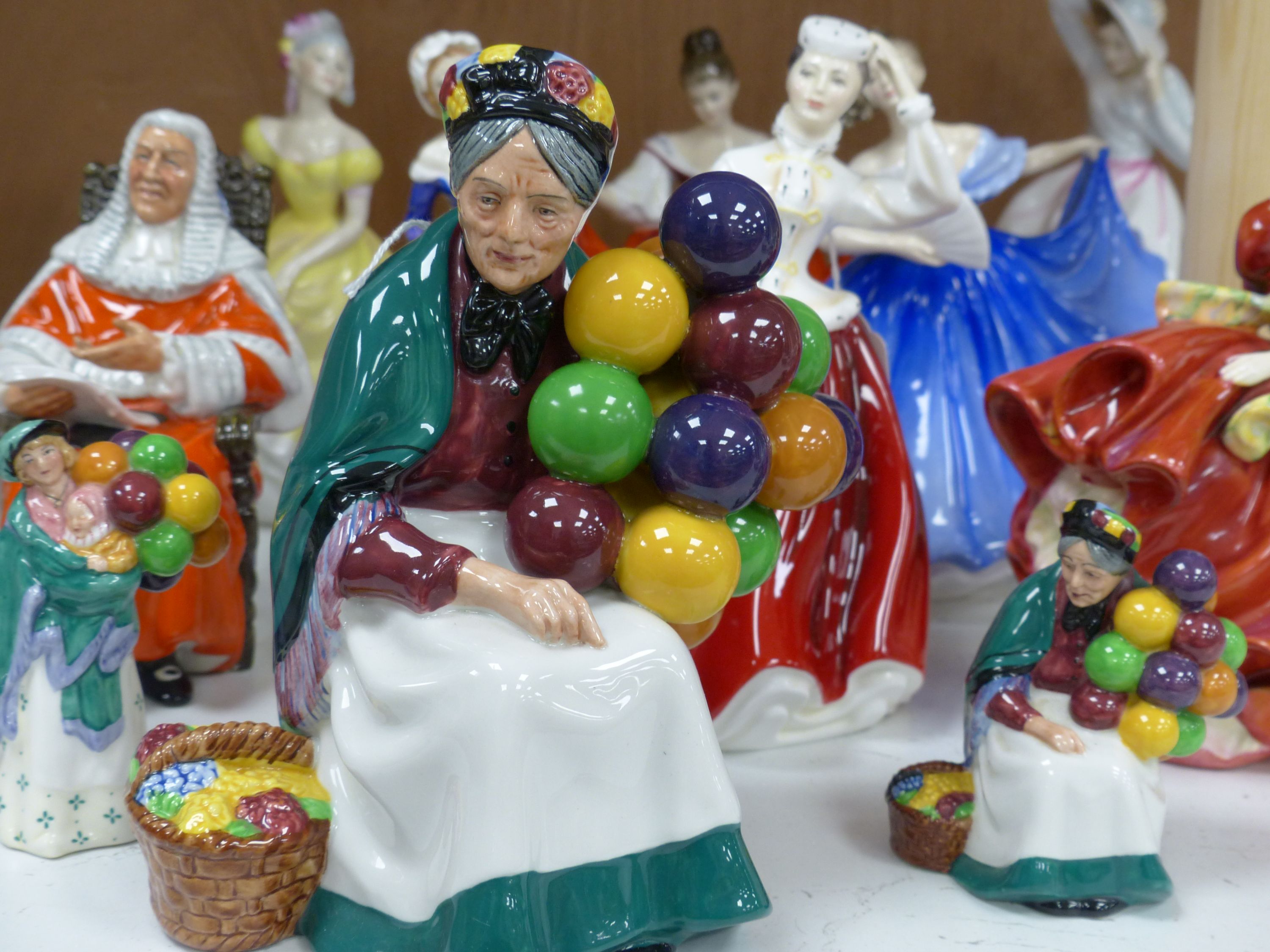 Ten Royal Doulton figurines, including 'Sara', 'The Judge', 'The Old Balloon Seller', 'Elaine' and others